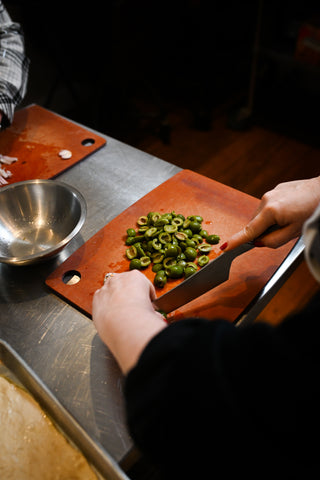 Chopping olives at an in-home private cooking class from The Recipe