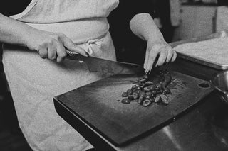 Close up of hands chopping olives at The Recipe.