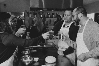 A group of guests clinking glasses during a class at The Recipe.